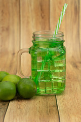 Lemonade summer cold drink with wooden background