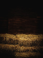 haystacks inside wooden barn