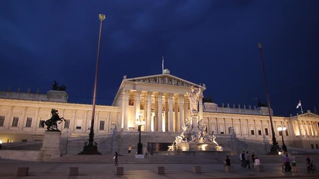 WS Traffic in front of Austrian Parliament Building during storm at night / Vienna, Austria