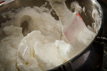 closeup whipped cream with salt in metal bowl