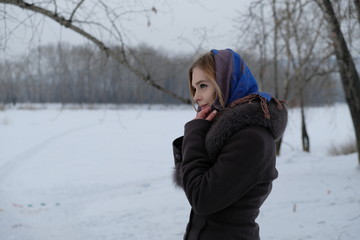 Fototapeta na wymiar Girl on a winter walk in the Siberian frost