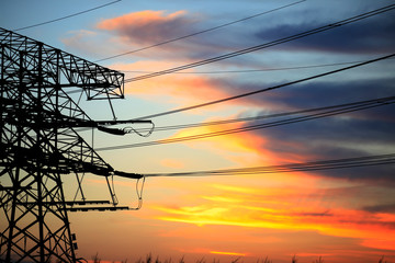 In the evening, the silhouette of high voltage towers