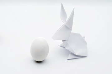 Origami white Easter bunny and egg.