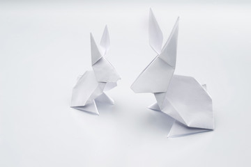 White origami rabbits on a white background.
