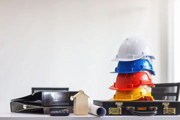 Safety helmet of engineer or worker on table in meeting room.