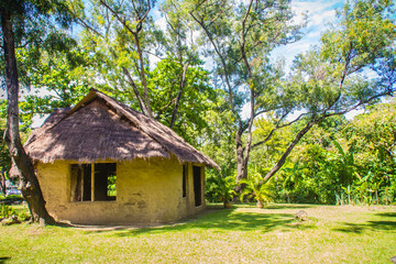 Earthen house under shade of trees. An earth house, also known as earth berm, earth sheltered home, or eco-house is an architectural style by use the natural terrain to help form the walls of a house.