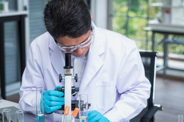 Scientists are doing research in science laboratories and microscopes are working devices.