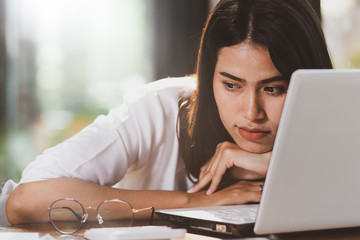 Asia woman working with serious and unhappy  in office.