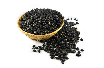 Pile of Black bean grain seeds on basket isolated on white background