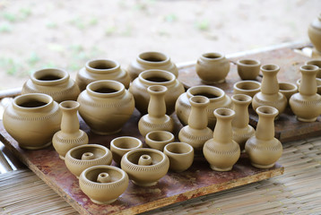 Closeup of fresh earthenware, pottery drying indoor with natural background. The classical and unique handmade product of Thailand. 