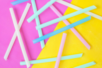 Cocktail tubes scattered on a yellow pink background
