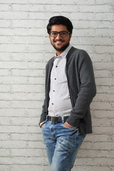Obraz premium Handsome man posing at brick wall