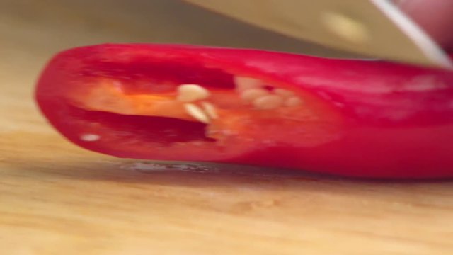 cutting chilli pepper on cutting board