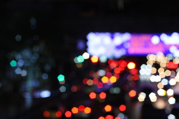 Blurred image of night life in the city. Traffic light bokeh in twilight time.