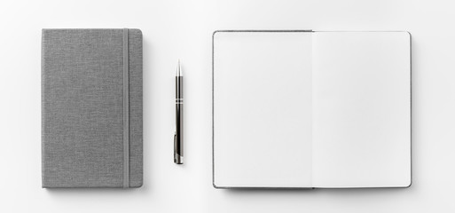 Business concept - Top view collection of  grey notebook front, back pen, and white open page...