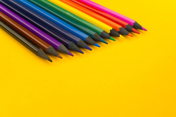 Black wood pencil on a yellow background. Ebony pencils.