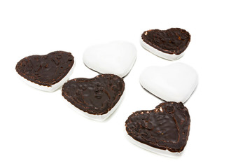 Gingerbread cookies in the form of hearts covered with white glaze and dark chocolate on an isolated background  