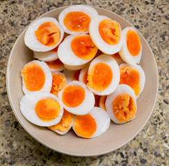 Medium-boiled egg, Top view. Hard boiled eggs, sliced in halves on bowl, street food form Asian.