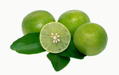 Limes with slices and leaves isolated on white background