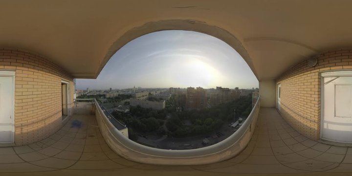 360 VR video. Moscow panorama with many typical apartment blocks, green park and distant Moscow State University. View from the upper store of the multistorey house at sunset