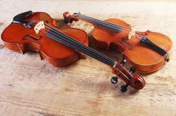 Fototapeta na wymiar Two violins on a wooden table