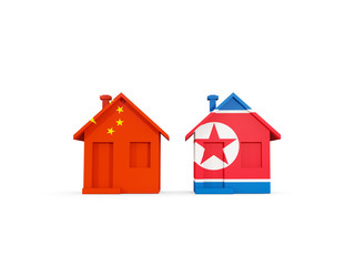 Two houses with flags of China and north korea
