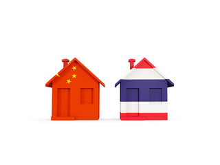 Two houses with flags of China and thailand