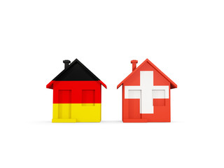 Two houses with flags of Germany and switzerland