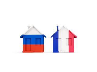 Two houses with flags of Russia and france