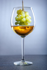 Glass of white wine and grapes. Alcohol concept.
