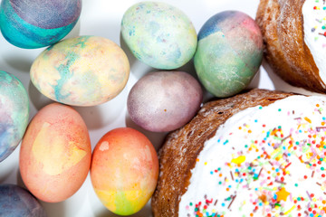 Two Easter cakes and colorful eggs on a white background