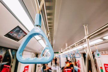 Handrails in a metro subway car , Handle or hand straps in MRT for the safety of passenger,Focus on a handrail.