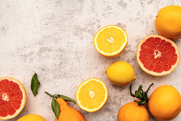 Various citrus fruits on marble background flat lay top view