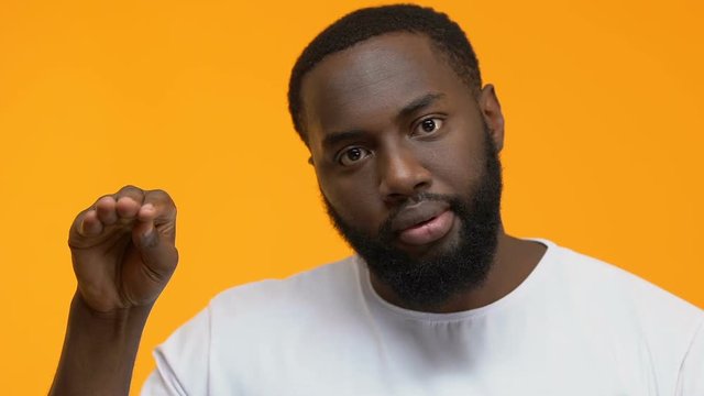 Irritated man showing bla-bla gesture, nonsense talking, gossips indifference