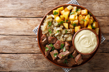 Swedish Beef Rydberg with fried onions and crisp potatoes with mustard sauce close-up. horizontal...