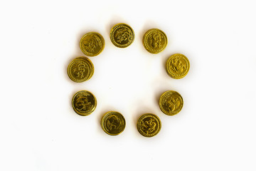 Bunch of chocolate gold coins on white background