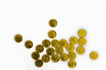 Bunch of chocolate gold coins on white background