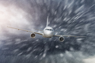 Airplane approach at the airport landing in bad weather strong wind with snow rain