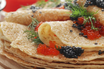 Russian pancakes with red and black caviar