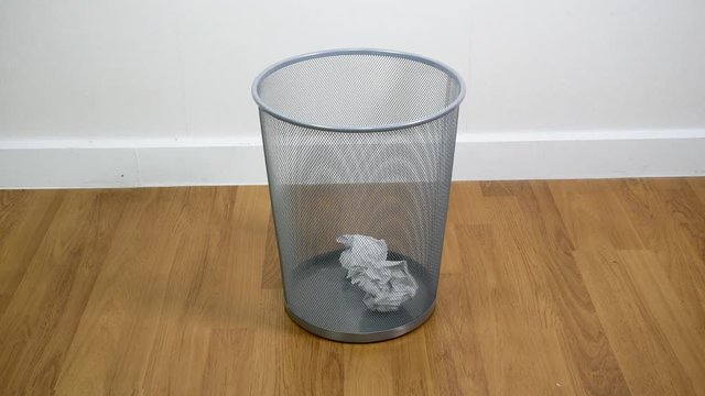 Throwing paper into the waste basket