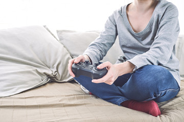 man holding a joystick controllers while playing a video games at home