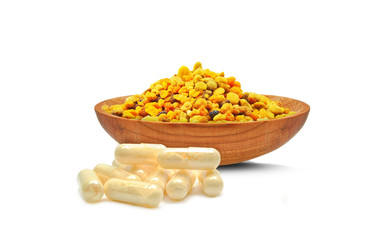 pollen in a bowl and royal jelly isolated on white