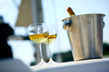 Pair of wineglasses against the yacht