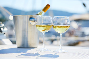 Pair of wineglasses against the yacht