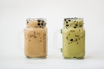 Two glass of drink Taiwan ice milk tea and Taiwan ice milk green tea with bubble boba on white background, Isolate drink in the glass.