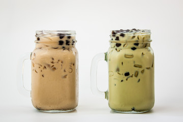 Two glass of drink Taiwan ice milk tea and Taiwan ice milk green tea with bubble boba on white background, Isolate drink in the glass.