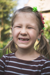 Child with a dental orthodontic device and without one tooth
