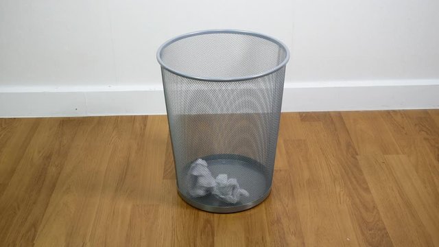 Throwing paper into the waste basket