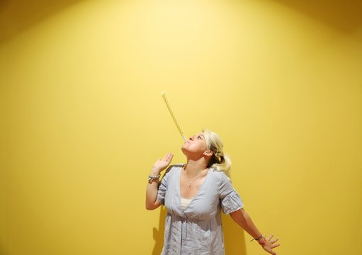 A young happy blond woman against colourful background