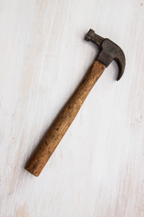 Vintage old handle steel hammer tool for carpenter on the wood paint white color background 